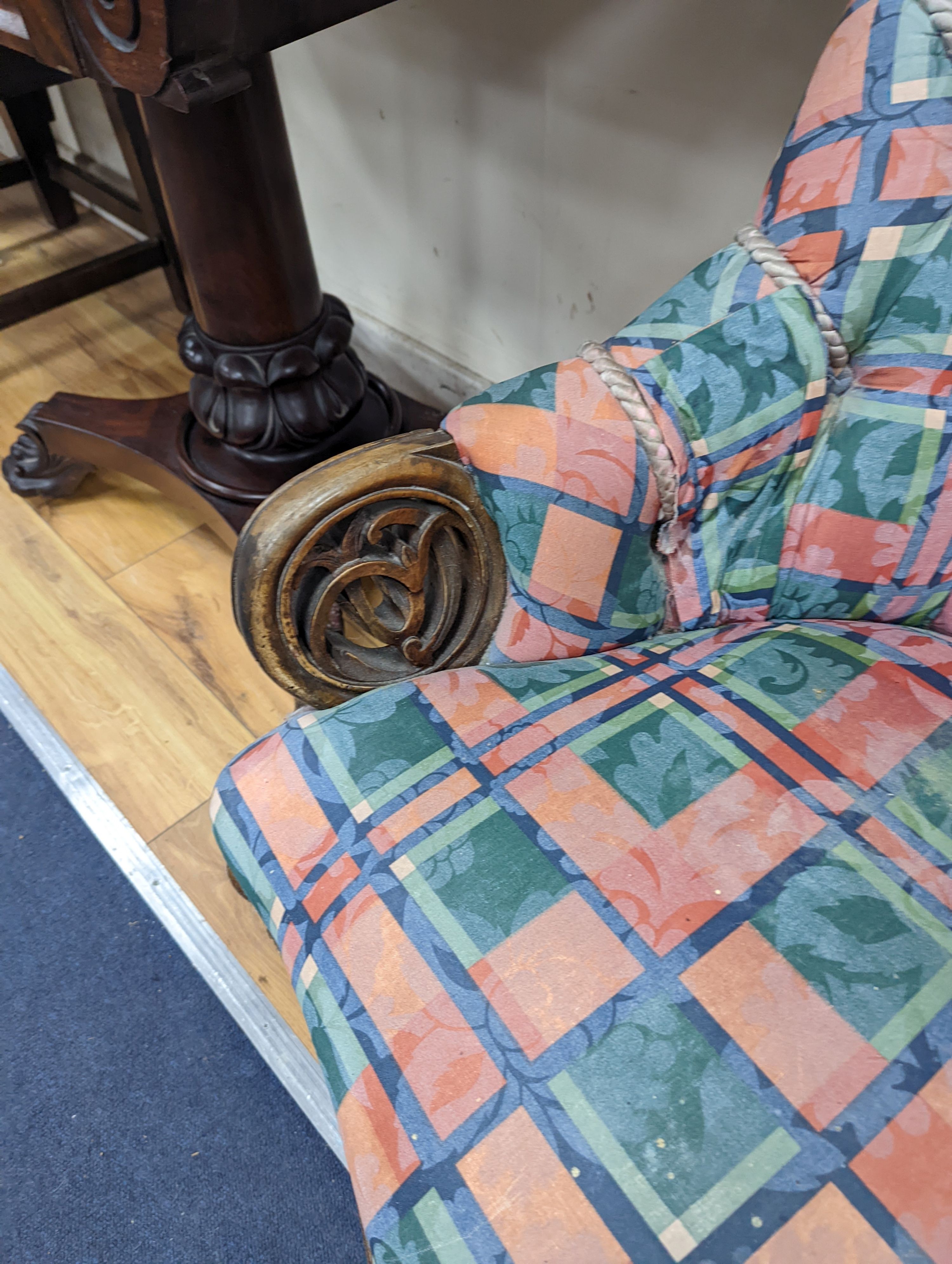 A Victorian carved walnut button back armchair
